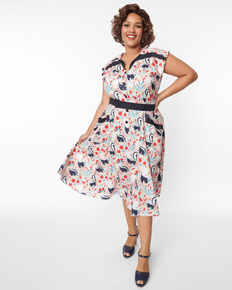 Front of a model wearing a size XL Unique Vintage Peach Skunk Print Hedda Swing Dress in Pink, Floral by Unique Vintage. | dia_product_style_image_id:289346